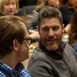 A discussion between two attendees